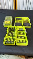 Four Ryobi bit cases displayed, two open driver kits, one open drill kit, one closed drill kit