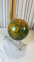 Oblique view of globe showing continents and Lucite stand