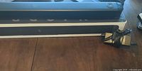 Sound bar on top of its box with AC adapter visible