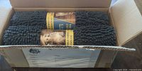 Open carton showing two rolled grey chenille pet mats with labels