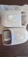 Both KNQZE hand massagers side by side showing control panels and inner cushions
