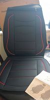 front view of assembled seat cover showing material and red piping