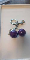 Single purple cherry keychain showing design and hardware