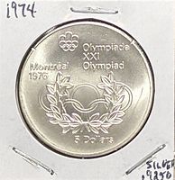 Reverse showing Olympic rings, laurel wreath, legend 'Olympiade XXI Olympiad Montréal 1976 5 Dollars'
