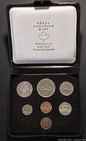 Open presentation case showing all seven coins in velvet insert with Royal Canadian Mint lid logo