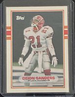 Card front in protective case showing Deion Sanders image and Topps logo