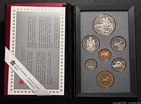 Open presentation case showing all seven proof coins and certificate