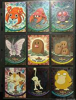Front view of nine holographic Pokémon cards in binder sheet