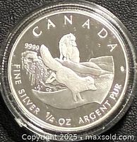 Reverse showing Arctic Fox design, purity and weight legends, coin in capsule