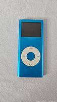 Front view of blue Apple iPod nano showing screen and click wheel