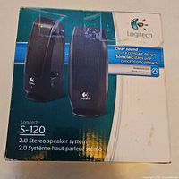 Front of Logitech S120 retail box showing image and specs