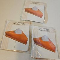 Front view of three identical packages labeled Inflatable Pumpkin Pie
