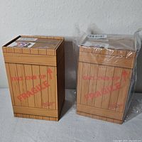 Two boxed sock sets, one wrapped in original plastic, crate design visible