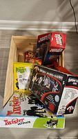 Wooden crate containing Twister Ultimate, Spontuneous, two Jenga boxes, Banana Blast