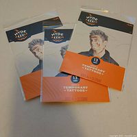 Front view showing four sealed packs with branding and 13-count label