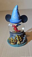 Full view of Mickey Mouse Fantasia Sorcerer snow globe showing hat, globe and base