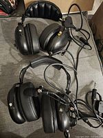 Both Flightcom headsets with cables and mics displayed