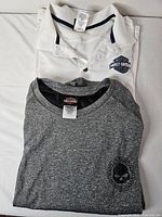 White polo and grey tee folded together