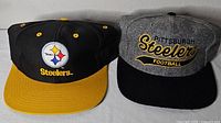 Both Steelers hats side by side showing fronts, colors and logos