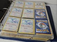 Binder page showing nine cards, eight Altaria plus card backs