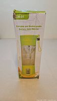 Front/side of boxed lime green CM-01 portable rechargeable blender
