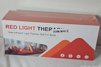 Front of sealed box showing product name and image of mat in use