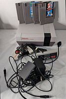 NES console with six game cartridges inserted part-way