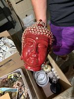 Glossy red Buddha head statue