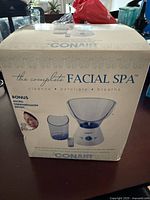 Front of sealed Conair Complete Facial Spa retail box showing product image and bonus microdermabrasion brush note.