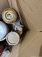 Top view of box showing gold mosaic candle holders and bowls