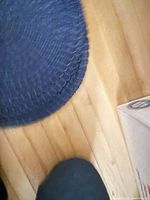 Stack of navy braided round placemats