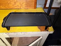 Overall view of black electric griddle on countertop