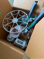 Box containing plant stand, pots, lanterns, hand tools, sprayer