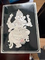 Silver foil Ganesha picture on black background