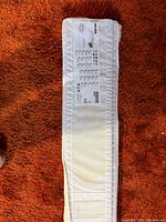 Folded white IKEA SKUBB organizer showing product label and size information