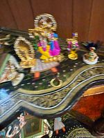 Gold-tone Radha-Krishna and other statuettes on surface