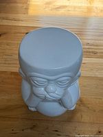 Top view of glossy white ceramic monkey stool