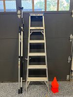 Group shot showing ladder, two extension poles and stacked cones