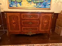 Front view showing marquetry panels, bronze mounts and overall form