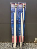 Two sealed flagpole kits side by side