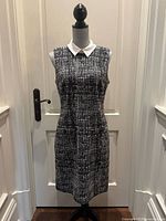 Front view of sleeveless tweed dress on mannequin