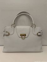 Full front view of white leather Ferragamo handbag showing overall design and shape