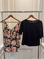 Both tops displayed on hangers