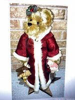 Full view of 26" plush bear in red coat on star-shaped wooden base