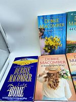 Front covers of Dakota Home, 8 Sandpiper Way, 74 Seaside Avenue and part of 44 Cranberry Point visible