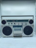 Front view showing speakers, cassette deck, tuner and controls