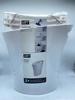 Front view of packaged LOFT bath set showing trash can and label