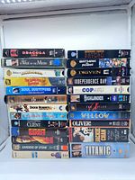 Both stacks of VHS tapes showing quantity and variety