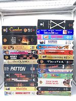 Front view showing two vertical stacks of 26 VHS tapes with visible titles