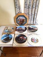 Seven plates displayed on table showing themes and quantity